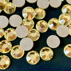 Photo does NOT do justice to these jonquil crystal flatbacks/rose chatons! Sold per lot of 24 crystal flatbacks. SKU 02009