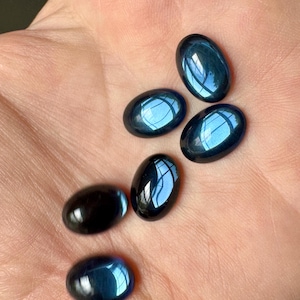 Marvelous Montana blue vintage W. German glass cabs!! Hard to tell from the photo, but dark blue Montana. Sold per six pieces. SKU 06524
