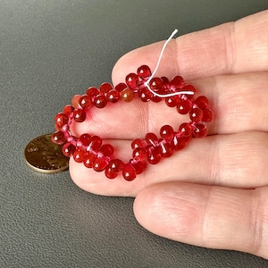 Gorgeous color in these Czech transparent cranberry drops!! Sold per lot of 50 beads. SKU 11704
