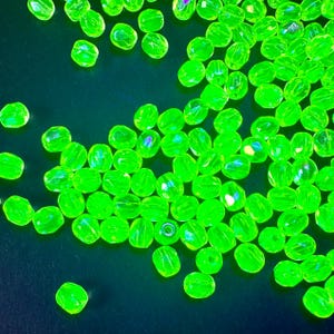 Authentic Vaseline/Uranium glass beads!! Czech firepolished 4mm in Jonquil AB. Bright glow under UV light. Sold per 25 beads. SKU 08705
