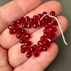 Beautiful transparent ruby Czech glass drops! Sold per lot of 50 beads. SKU 09620