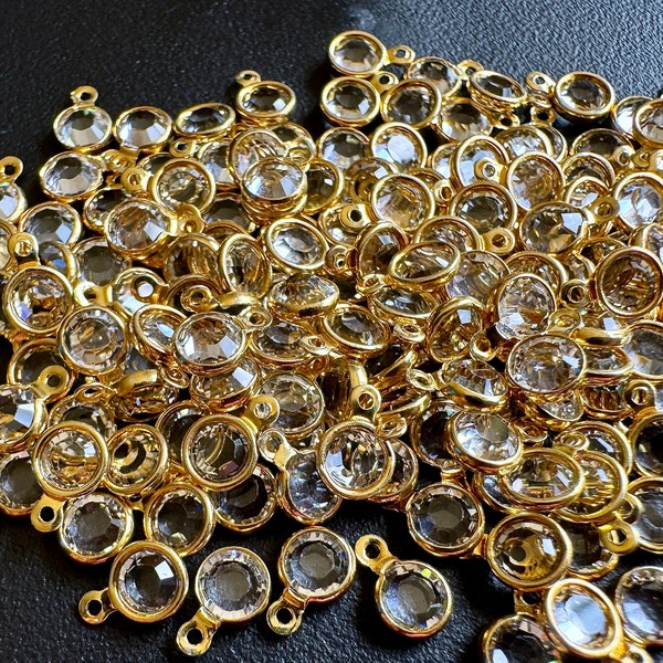 Gorgeous Swarovski faceted crystal drops! Double sided clear crystal with gold plated brass settings. Sold per 16 pieces. SKU 15512
