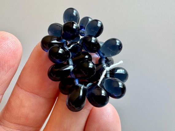 Gorgeous Czech pressed glass teardrops in transparent Montana blue! Sold per strand of 25 beads. SKU 11505