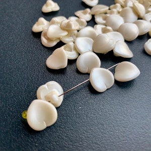 Incredible find! Vintage Haskell glass pearls!! Very unusual shape--is it a heart or a leaf? Sold per lot of ten pieces. SKU 14518