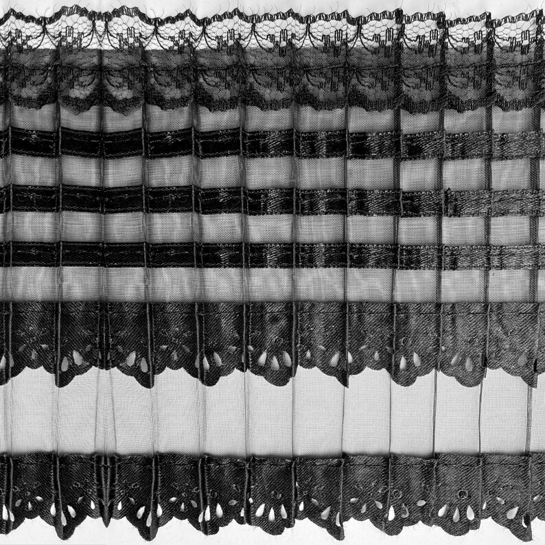May include: Black and white striped sheer curtain valance with a scalloped lace trim. The valance has a delicate, feminine design.