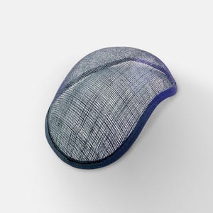 May include: A blue and purple hat base made of woven straw. The base is shaped like a rounded oval and has a dark blue trim.