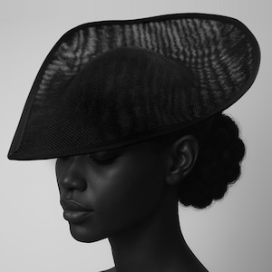 May include: A black hat with a wide, asymmetrical brim and a structured crown. The hat's brim extends over the face, creating a dramatic silhouette. The hat is made of a woven material, and the overall design is elegant and sophisticated.