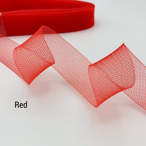 May include: Red mesh ribbon with a fine, delicate weave. The ribbon is folded and displayed on a white background.