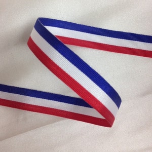 May include: Red, white, and blue ribbon with a striped pattern.