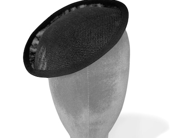 May include: A black mesh hat with a rounded shape. The hat is on a grey mannequin head.