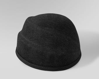 May include: A black mesh cap with a rounded crown and a slightly curved brim. The cap has a textured appearance and a dark trim along the edge. The hat is a solid colour and is suitable for casual wear.