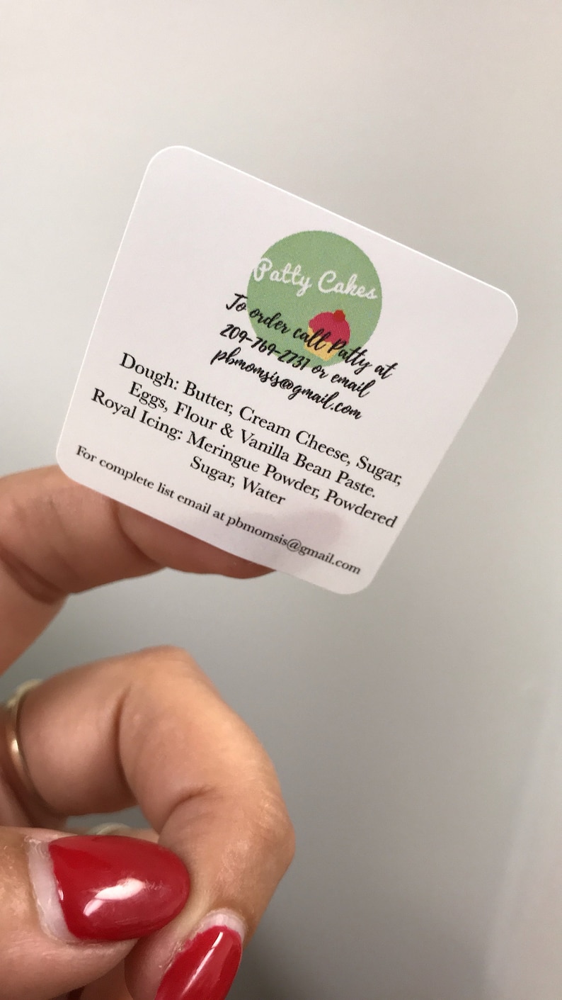 May include: A white business card with the text "Patty Cakes" in green and red. The card includes the text "To order call Patty at 209-769-2731 or email pbmomsis@gmail.com". The card also lists the ingredients used in the cakes, including butter, cream cheese, sugar, eggs, flour, vanilla bean paste, meringue powder, powdered sugar, and water.