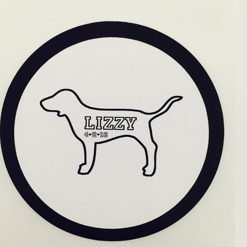 May include: Black and white silhouette of a dog with the name "Lizzy" and the date "4-2-16" printed on a white circle with a black border.