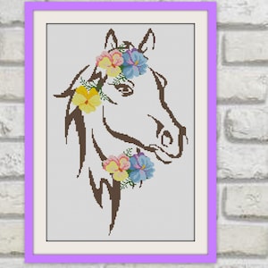 May include: Cross-stitch artwork depicting a horse's head in profile, decorated with a floral crown and accents. The horse is brown, set against a white backdrop, framed in a purple border. The flowers are yellow, pink, and blue.
