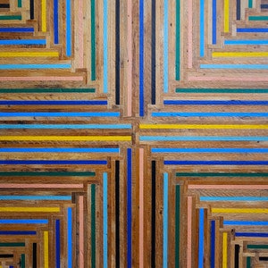 Close up detail of table top with colorful geometric stripe pattern.