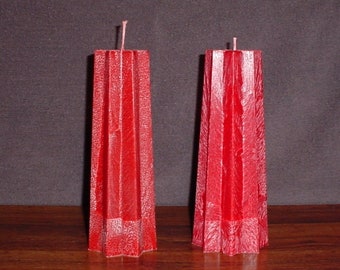 Pair of tapered 8 point star red palm wax candles