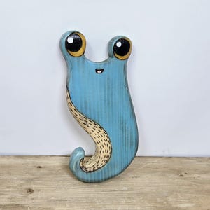 Houten muurdecoratie met naaktslak