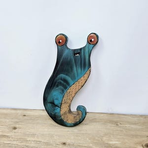 Houten muurdecoratie met naaktslak