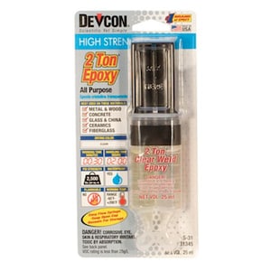 May include: A clear plastic bottle of 2 Ton Clear Weld Epoxy adhesive. The bottle is labeled with the product name, a warning label, and the net volume of 25 ml. The bottle is packaged in a cardboard box with a black and white label that includes the product name, a list of materials it can be used on, and instructions for use.