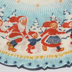 May include: A circular Christmas tree skirt with a scalloped edge. The design features a festive scene with Santa Claus, children, and snow-covered trees in red, blue, and white. Stars and snowflakes decorate the border.