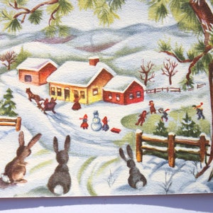 Vintage Christmas Card with Cute Bunny Rabbits and House in old fashioned Snow filled landscape