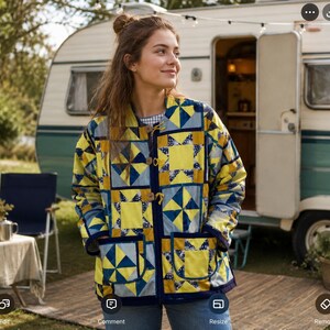 May include: A quilted jacket featuring a patchwork design of yellow, blue, and grey geometric patterns. The jacket has a round neckline, long sleeves, two large front patch pockets, and is fastened with three wooden toggle buttons down the front.