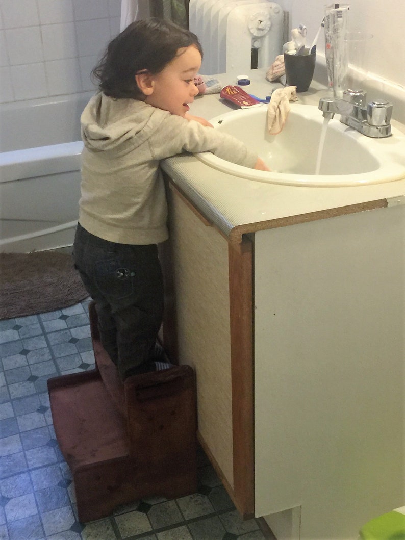 Handles make it easy to carry Solid spruce. Personalized Two-Step stool with Minwax stain of your choice