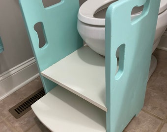 Get up and GO Potty Helper 2-Step Stool. Has  4 handles for ease of use. Sturdy and SAFE, glued & screwed. White steps, Refresh (Aqua) sides