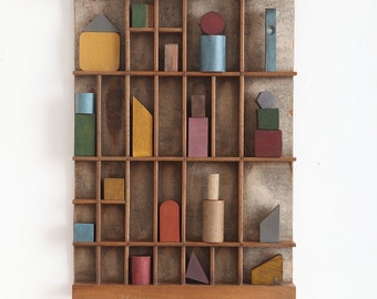 Decorative Artwork of Old Wooden Blocks & Shapes in Vintage Printers Tray Cabinet