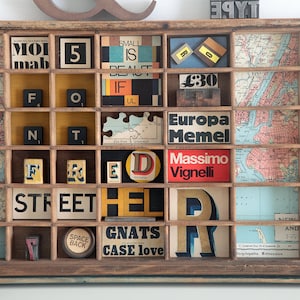 Schröckliges typografisches Wandkunst-Kunstwerk in einer alten Drucker-Setzkastenschublade