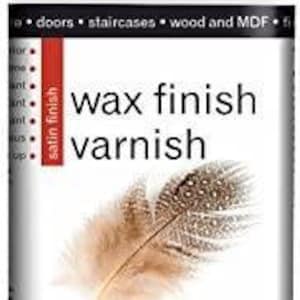 May include: A white bottle of Polyvine Wax Finish Varnish with a black lid. The bottle has a clear satin finish and is labeled with the text "wax finish varnish" and "clear satin".