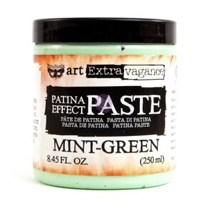 May include: A mint-green Patina Paste in a round container with a black lid. The label features the text "art Extravagance" and "PATINA PASTE EFFECT". The container holds 8.45 fl oz (250 ml) of paste.