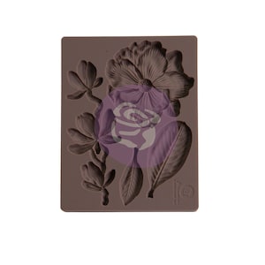 May include: A brown silicone mold with a design of a large flower, smaller flowers, and leaves. The mold is for making decorative items.