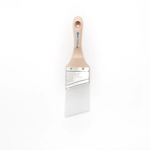 May include: A white angled paint brush with a wooden handle. The handle has the brand name "Zebra" printed on it in blue.