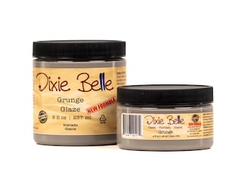 May include: Two jars of Dixie Belle Grunge Glaze, one 8 fluid ounce jar and one 4 fluid ounce jar. Both jars are gray and have a black lid. The larger jar has the text "NEW FORMULA" on the label.