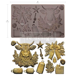 May include: A rectangular silicone mold measuring 8 inches by 5 inches, featuring cavities for a cow head with pine branches, a large bow, bells, a star, pinecones, and a square tag. Below, gold-colored castings show the finished shapes.