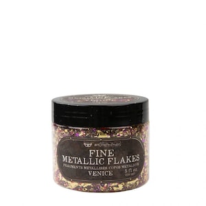 May include: A jar of fine metallic flakes in a gold, purple, and red color scheme. The jar is labeled "art ingredients FINE METALLIC FLAKES FRAGMENTS METALLISES COPOS METALICOS VENICE 5 fl. oz. (150 ml)"