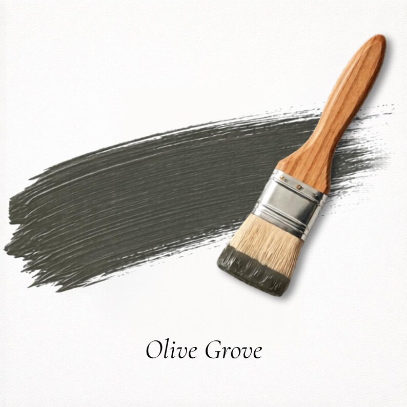 May include: A paintbrush with a wooden handle and silver ferrule is shown next to a stroke of olive green paint. The paint swatch is textured and the words "Olive Grove" are written below the paint swatch.