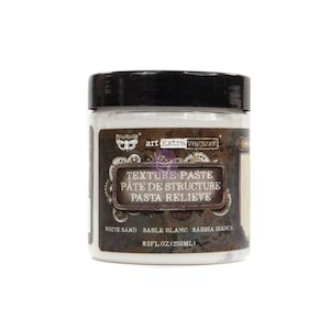 May include: A white jar of Pinnabair art Extra vaganc Texture Paste, Pâte de Structure, Pasta Relieve. The jar is labeled with white sand, sable blanc, sabbia bianca, and 8.5 fl oz (250 ml).