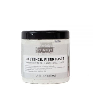 May include: A white plastic jar with a black lid containing 3D Stencil Fiber Paste. The jar is labeled "re-design with Prima DIY Simplified" and "3D Stencil Fiber Paste Pochoir Pate de 3D Plantilla Pasta de 3D". The jar contains 16.9 fl. oz. (500 ml) of paste.
