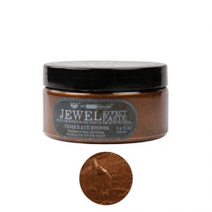 May include: A 3.4 fl oz jar of gold metallic Jewel Effect Paste for crafting. The label reads "Jewel Effect Paste" and "Tiger's Eye Stones".