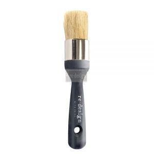 May include: A paint brush with a natural bristle head, a silver ferrule, and a dark gray handle. The handle has the text "re-design with Prima". The brush is designed for painting and crafting.