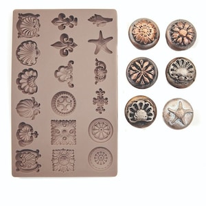 May include: A silicone mold with 18 different designs, including seashells, fleur-de-lis, and stars. The mold is shown with 8 finished resin pieces in various colors and designs.