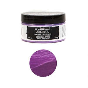 May include: A 4.1 fluid ounce jar of purple icing paste. The jar has a black lid and a white label with the text "art extravagance" and "Icing Paste, Pate de Glacis, Pasta de Glaseado, Amethyst Magic, Magie Amethyst, Magia Amatista".