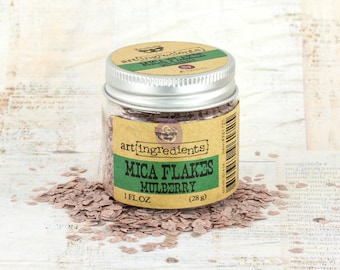 May include: A small glass jar with a silver lid filled with pink mica flakes. The jar has a brown label with the text "art ingredients Mica Flakes Mulberry 1 fl oz (28 g)".