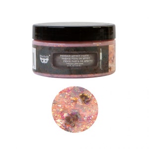May include: A jar of iridescent glitter paste labeled "Phoenix Effect Paste" in pink, gold, and black lettering. The paste is a light pink color with gold and iridescent glitter throughout.