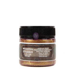 May include: A 1.7 fluid ounce (50 ml) bottle of gold acrylic paint labeled "Sparks" by Art Alchemy. The label also includes the text "Acrylic Paint, Peinture à l'Acrylique, Pintura Acrílica, Chest of Gold, Coffre d'or, Cofre de oro."