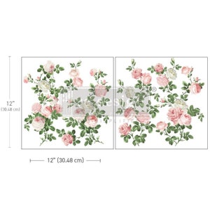May include: Two white rectangular floral design transfers, each 12 inches (30.48 cm) wide and 12 inches (30.48 cm) high. The transfers feature pink and white roses with green leaves and stems. The word "design" is visible.
