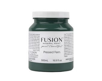 May include: A 16.9 fluid ounce bottle of Fusion Mineral Paint in the color Pressed Fern. The bottle is green and has a white label with the Fusion logo and the paint color name.