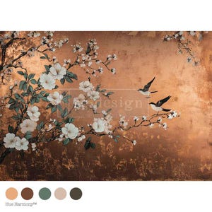 May include: A decorative panel featuring a floral design with white blossoms and green leaves on a copper-colored background. Two birds are perched on a branch. The word "design" is visible in the center of the image.